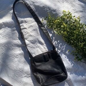 Stone Mountain Accessories brown leather purse with buckle strap.